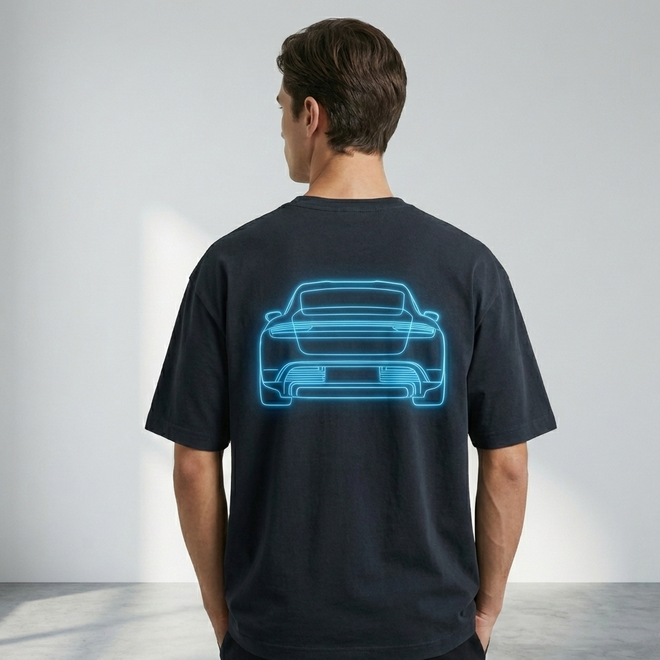 Person wearing a black t-shirt with a blue car outline on the back against a plain background