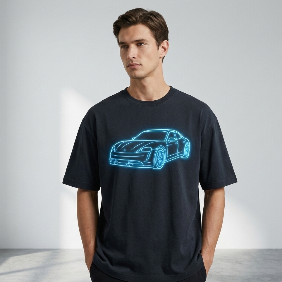 Man wearing a black t-shirt with a blue car outline design on a plain background