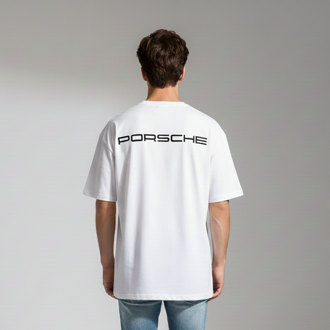 Person wearing a white Porsche t-shirt with the brand logo on the back, standing against a plain background.