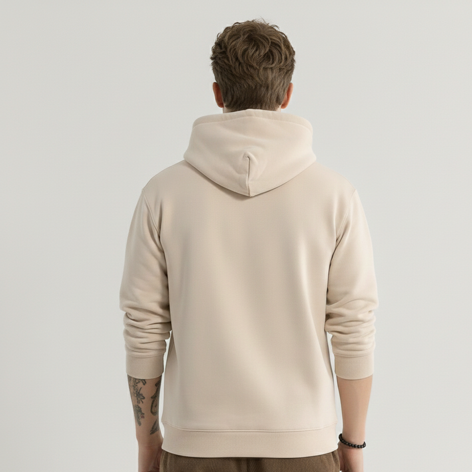Person wearing a beige hoodie from behind on a light gray background