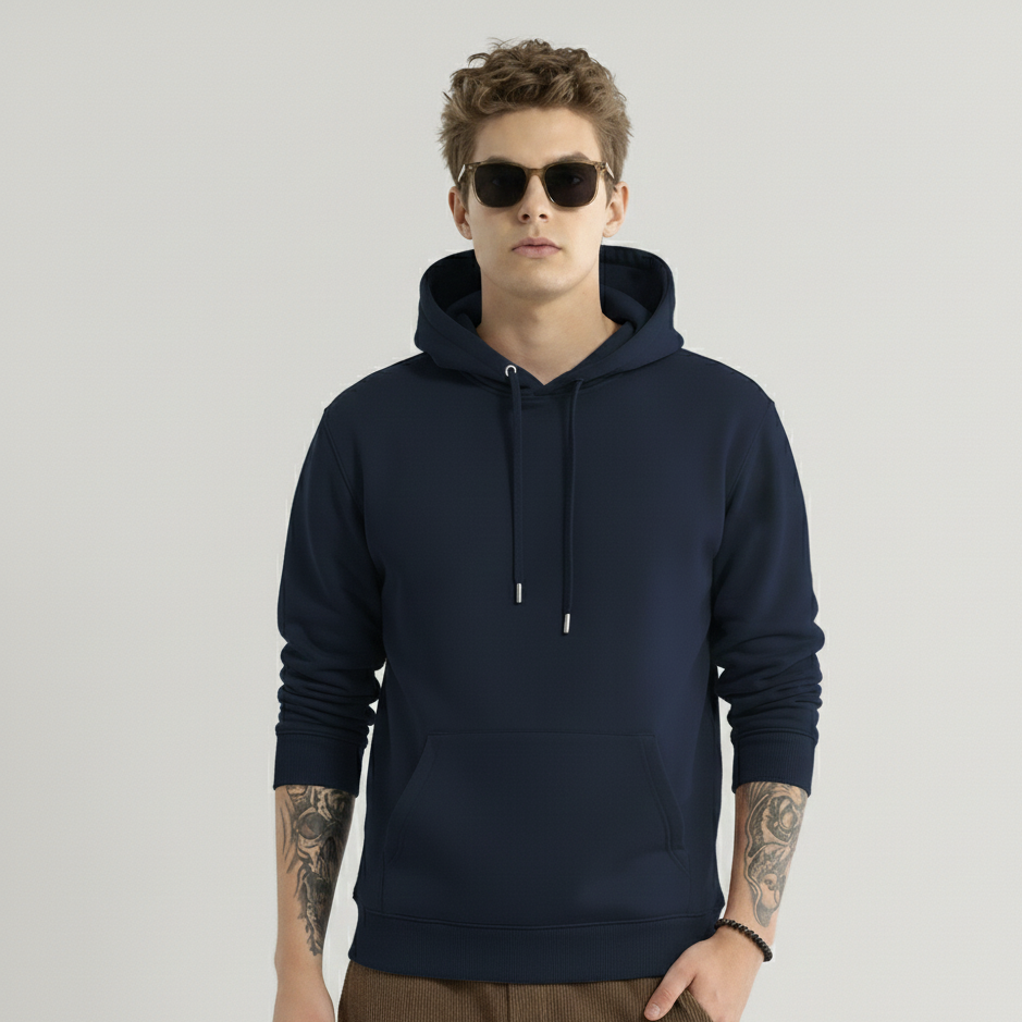 Man wearing a navy blue hoodie and sunglasses on a light gray background