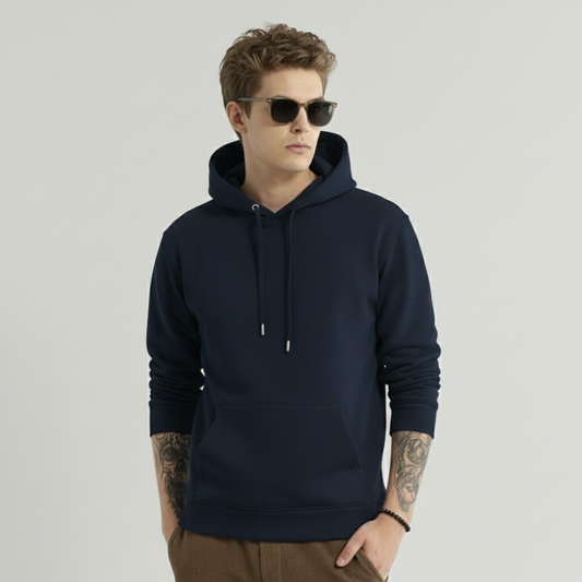 Man wearing a navy blue hoodie and sunglasses on a light gray background