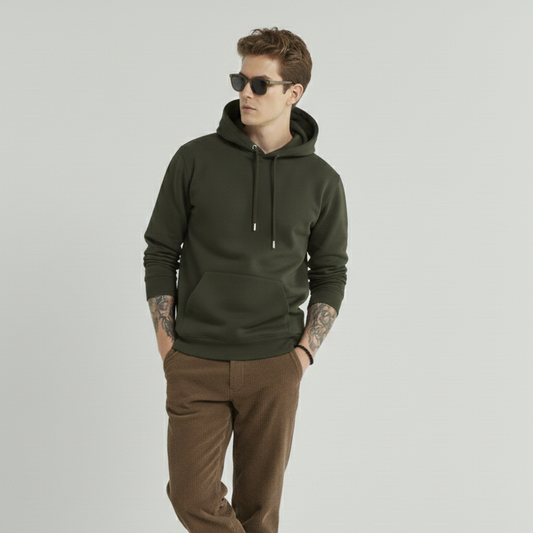 Man wearing a green hoodie and brown pants on a gray background