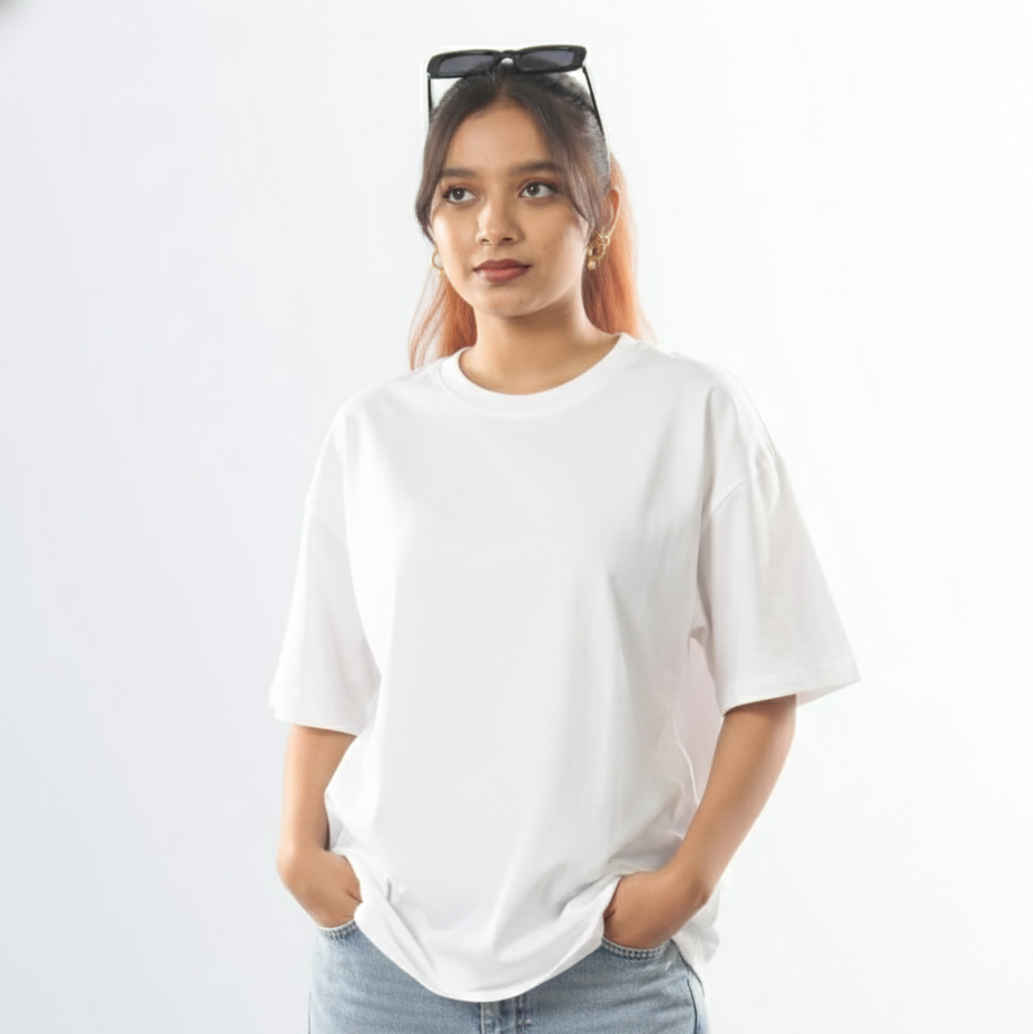 Woman wearing a white t-shirt and light blue jeans against a plain background