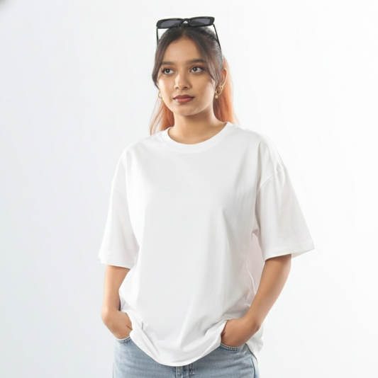 Woman wearing a white t-shirt and light blue jeans against a plain background