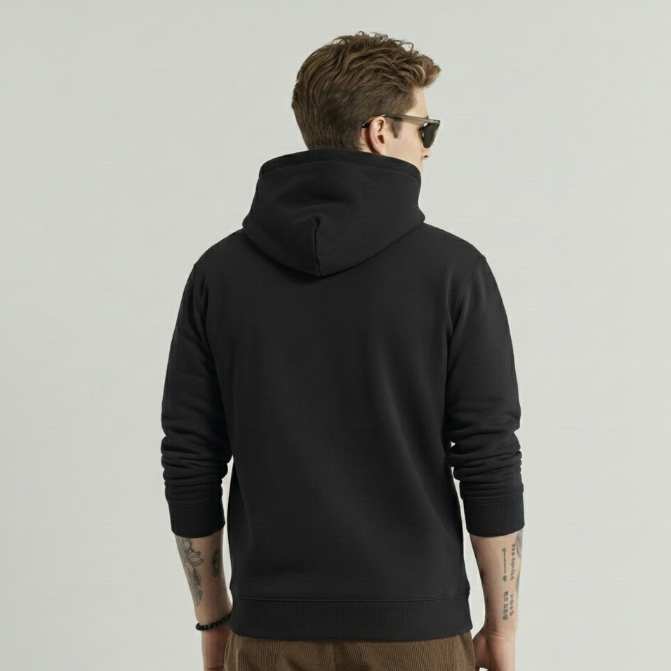 Person wearing a black hoodie from behind on a plain background