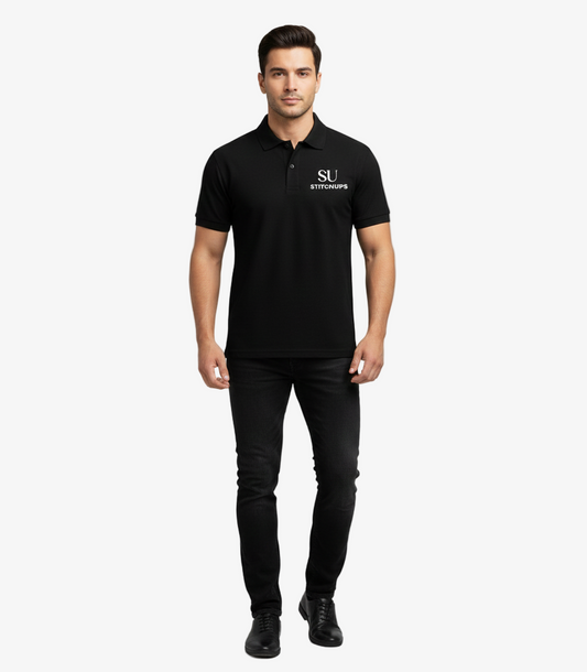 Man wearing a black polo shirt with a logo on a gray background