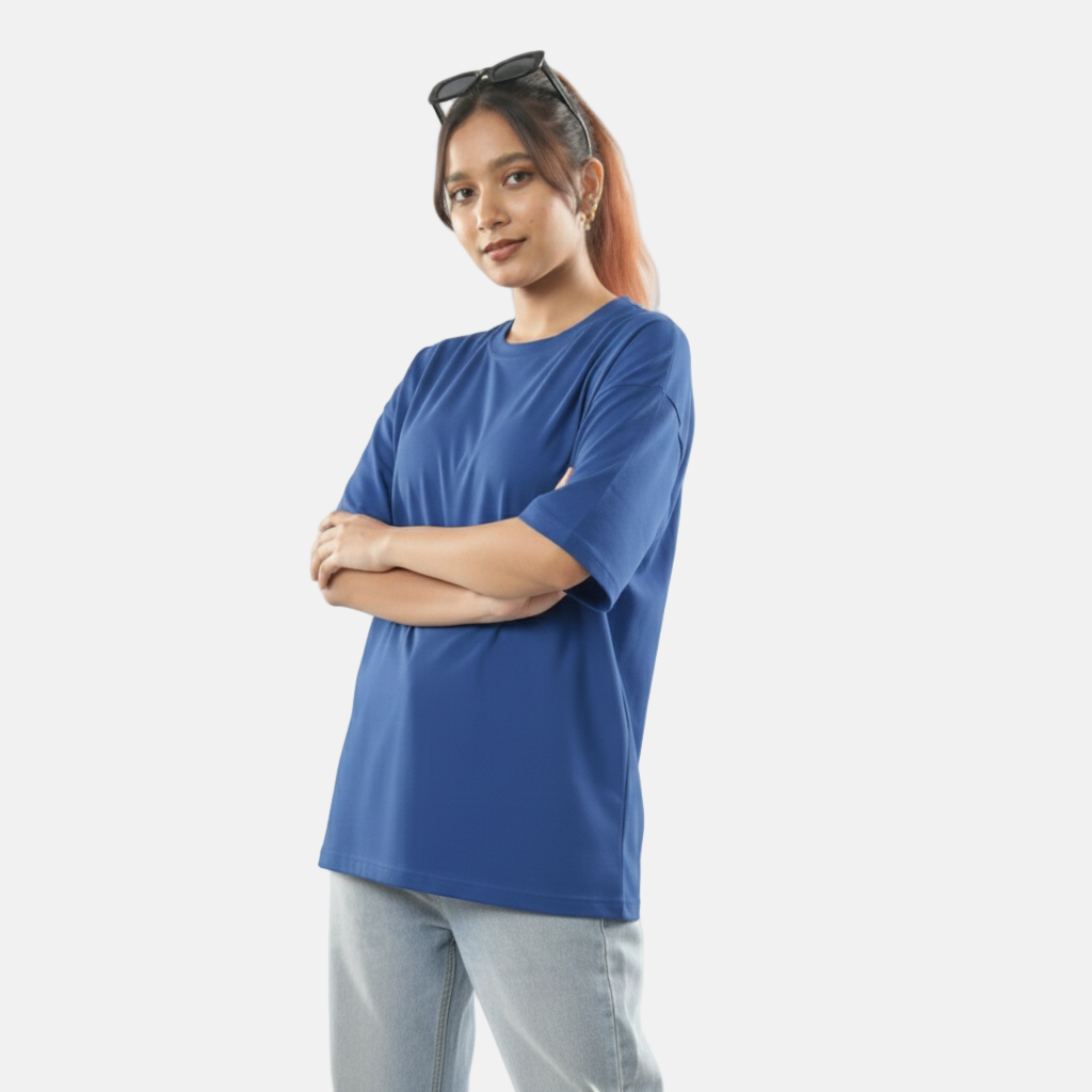 Woman wearing a blue t-shirt and light gray pants on a white background